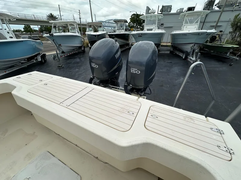 Slide: The Image of 2011 Parker 25 boat with twin Yamaha 150 engines in a marina setting. - 14