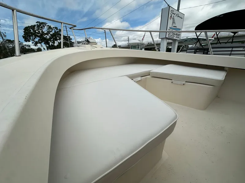 Slide: The Image of 2011 Parker 25 boat with cushioned seating and sleek design under a cloudy sky. - 15