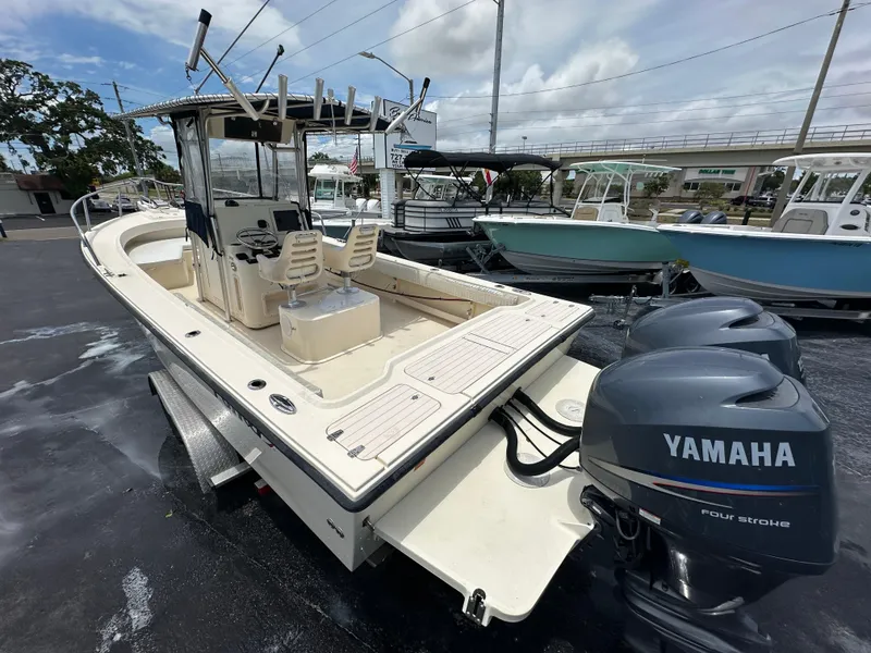 Slide: The Image of 2011 Parker 25 boat with Yamaha outboard motors, docked under a cloudy sky. - 4