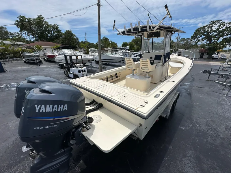Slide: The Image of 2011 Parker 25 boat with dual Yamaha engines in a marina setting. - 8