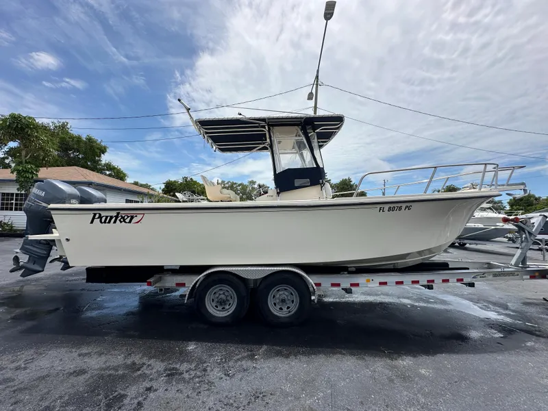 Slide: The Image of 2011 Parker 25 boat on trailer under cloudy sky. - 9
