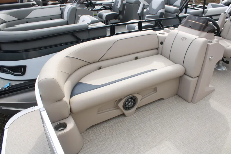 Slide: The Image of 2024 Tahoe Pontoon Sport 2385 QL interior with beige seating and integrated speaker system. - 4