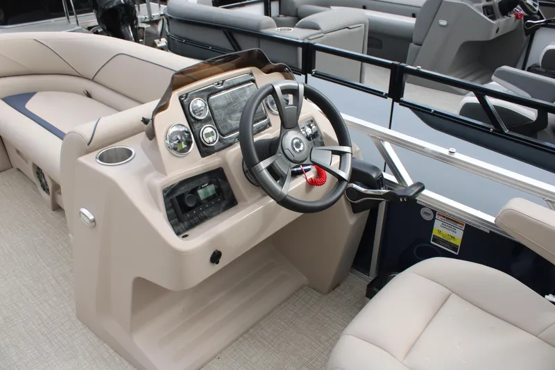 Slide: The Image of 2024 Tahoe Pontoon Sport 2385 QL dashboard with steering wheel and controls. - 6