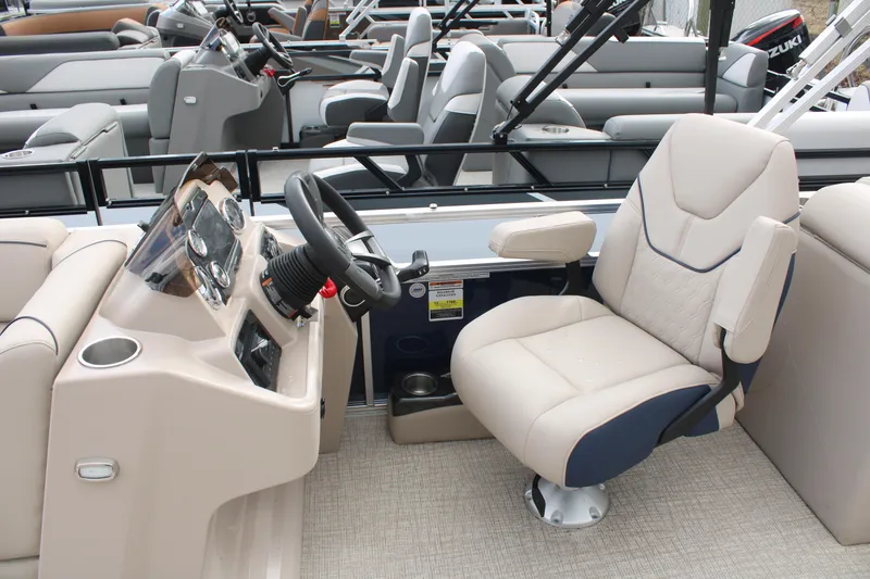 Slide: The Image of 2024 Tahoe Pontoon Sport 2385 QL interior with captain's chair and steering console. - 7
