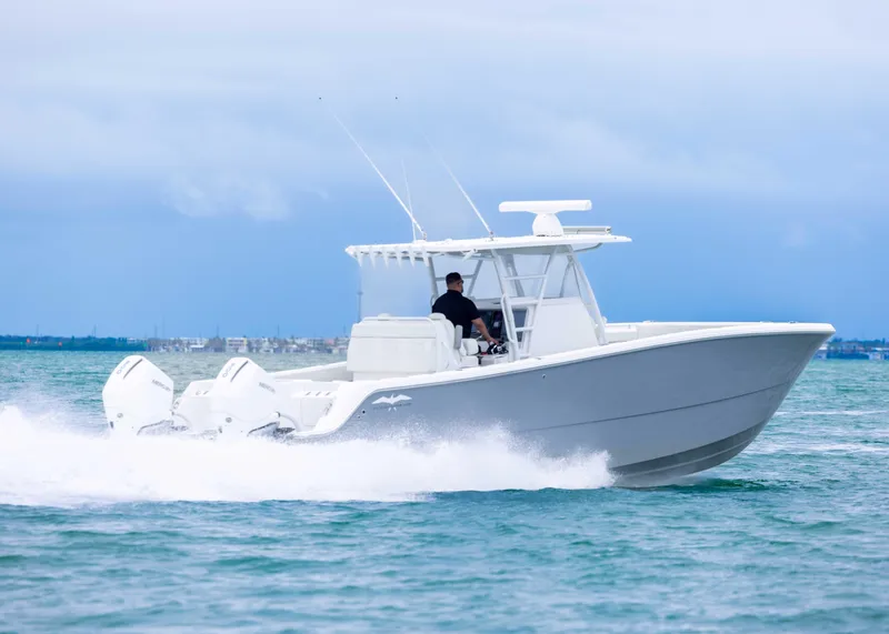 Slide: The Image of 2023 Invincible 33 Catamaran cruising on open water, showcasing sleek design and powerful engines. - 10