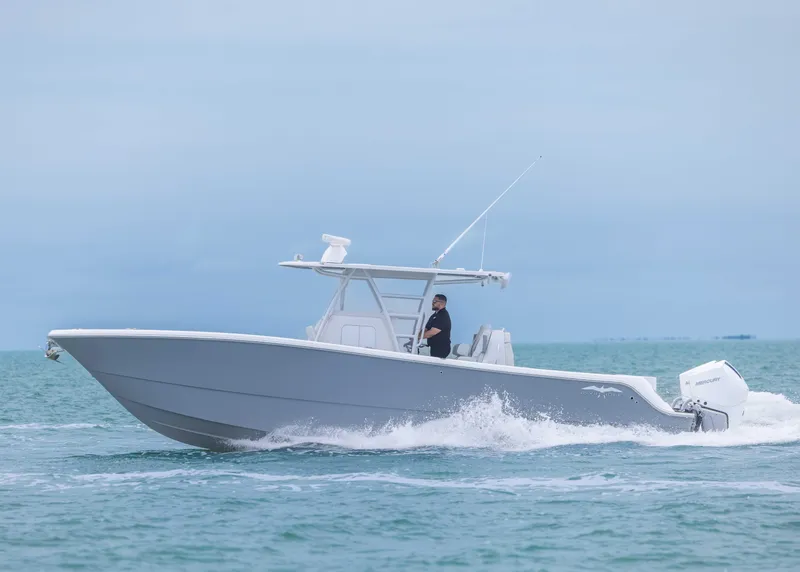 Slide: The Image of 2023 Invincible 33 Catamaran cruising on open water, side view. - 11