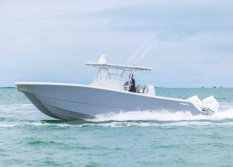 Slide: The Image of 2023 Invincible 33 Catamaran cruising on open water, showcasing sleek design and powerful engines. - 12