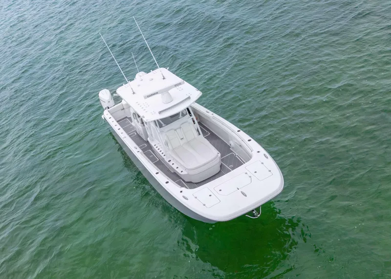 Slide: The Image of 2023 Invincible 33 Catamaran on clear green water, aerial view. - 13