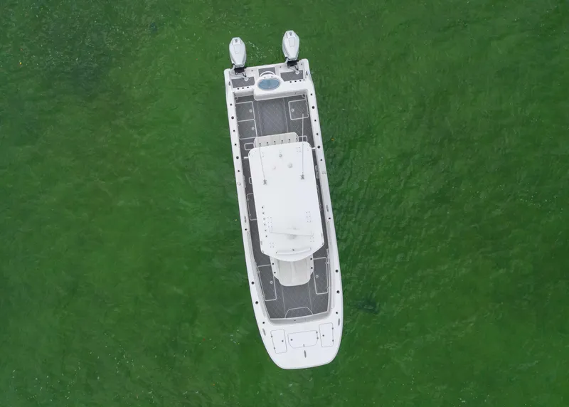 Slide: The Image of Aerial view of 2023 Invincible 33 Catamaran on green water. - 14