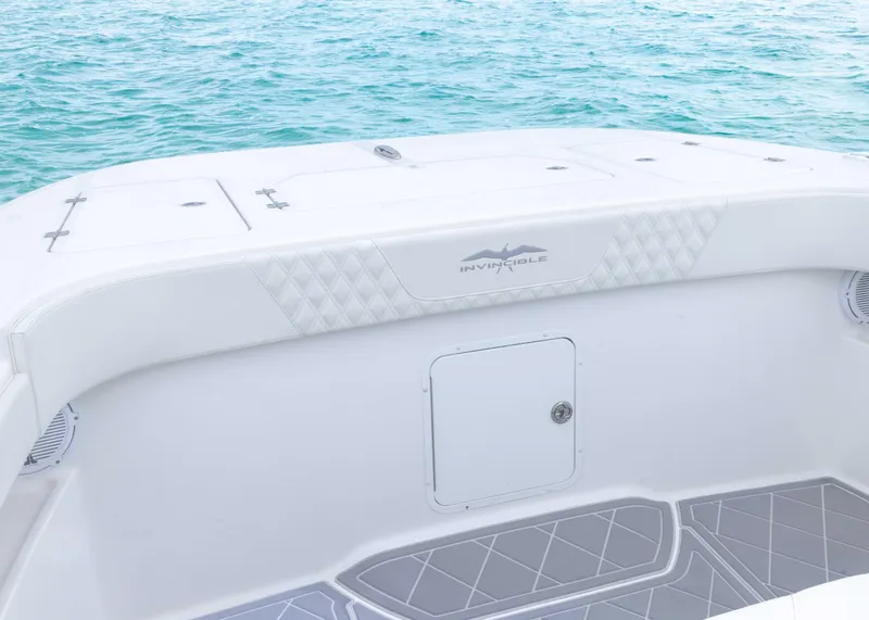 Slide: The Image of 2023 Invincible 33 Catamaran deck with ocean backdrop, featuring sleek design and storage compartment. - 15