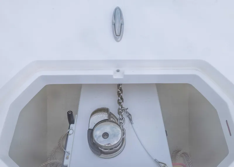 Slide: The Image of Anchor compartment of 2023 Invincible 33 Catamaran with chain and winch. - 16
