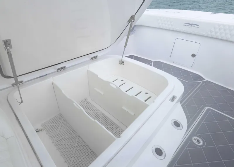 Slide: The Image of 2023 Invincible 33 Catamaran storage compartment with open lid, showcasing spacious interior design. - 18
