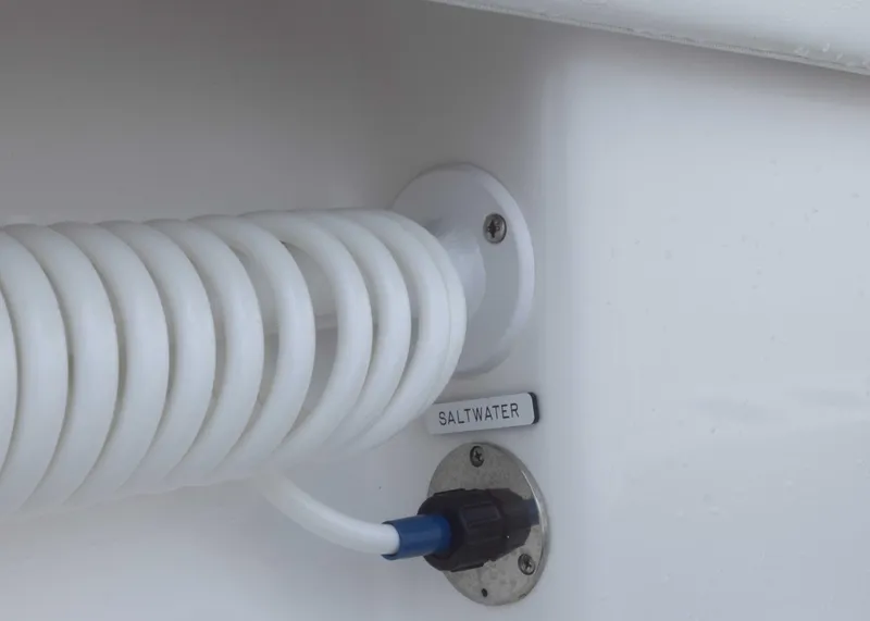 Slide: The Image of Coiled hose and saltwater outlet on 2023 Invincible 33 Catamaran. - 20