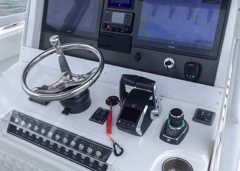 Slide: The Image of Control panel of 2023 Invincible 33 Catamaran with steering wheel and navigation screens. - 27