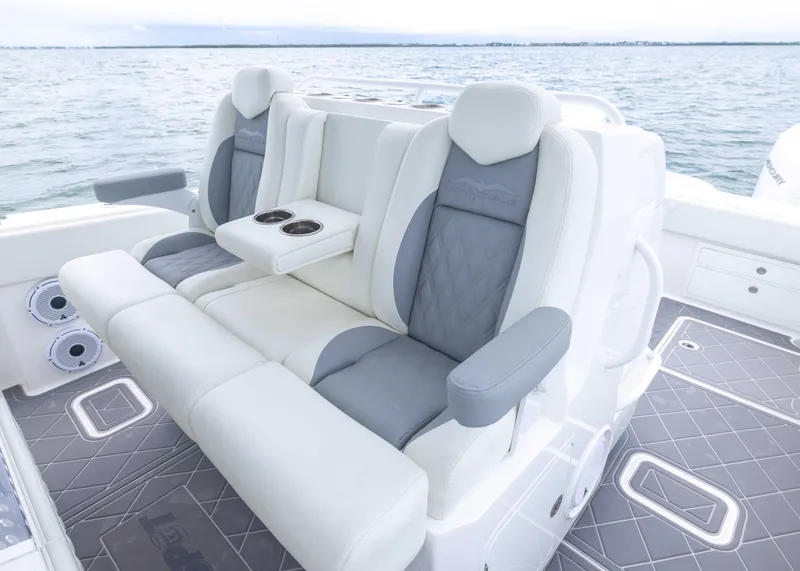 Slide: The Image of Luxury seating on 2023 Invincible 33 Catamaran, featuring comfortable armrests and cup holders. - 29