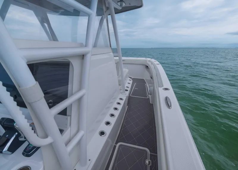 Slide: The Image of 2023 Invincible 33 Catamaran on open water, showcasing sleek deck design and ocean view. - 30