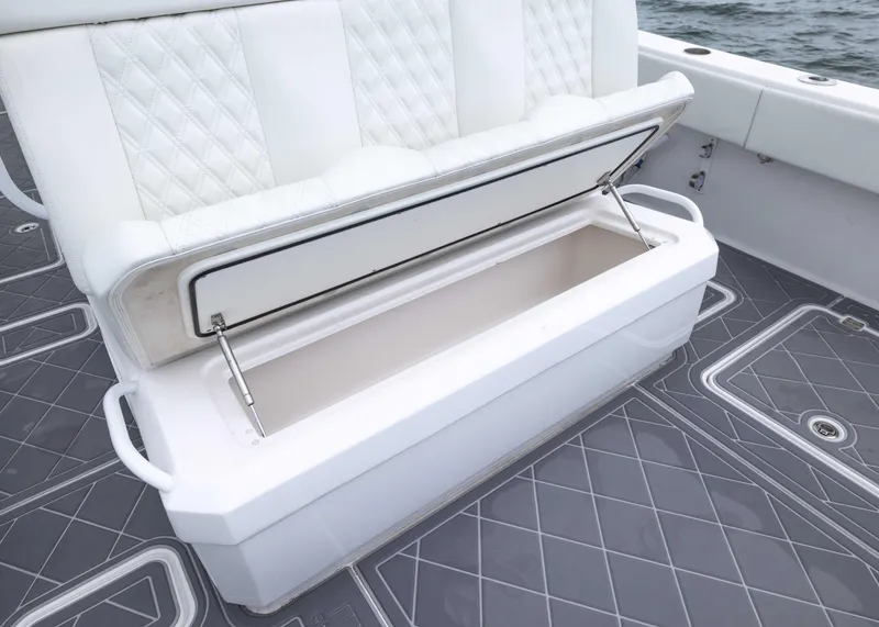 Slide: The Image of 2023 Invincible 33 Catamaran with open storage compartment on deck, featuring quilted seating. - 32