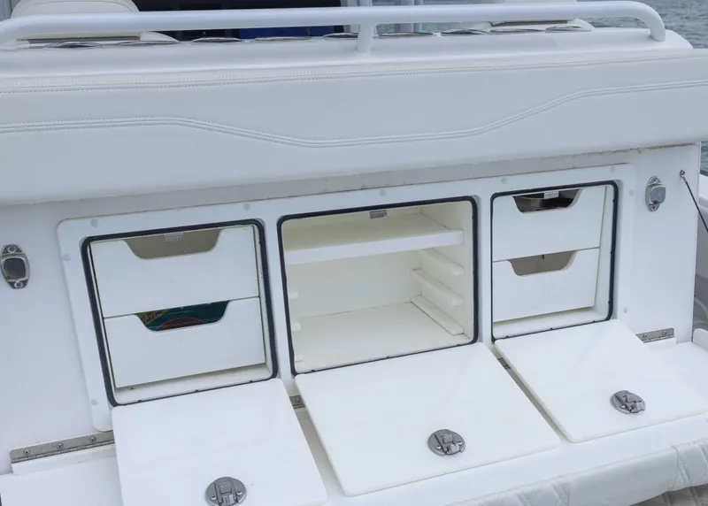 Slide: The Image of 2023 Invincible 33 Catamaran storage compartments with white finish and sleek design. - 33