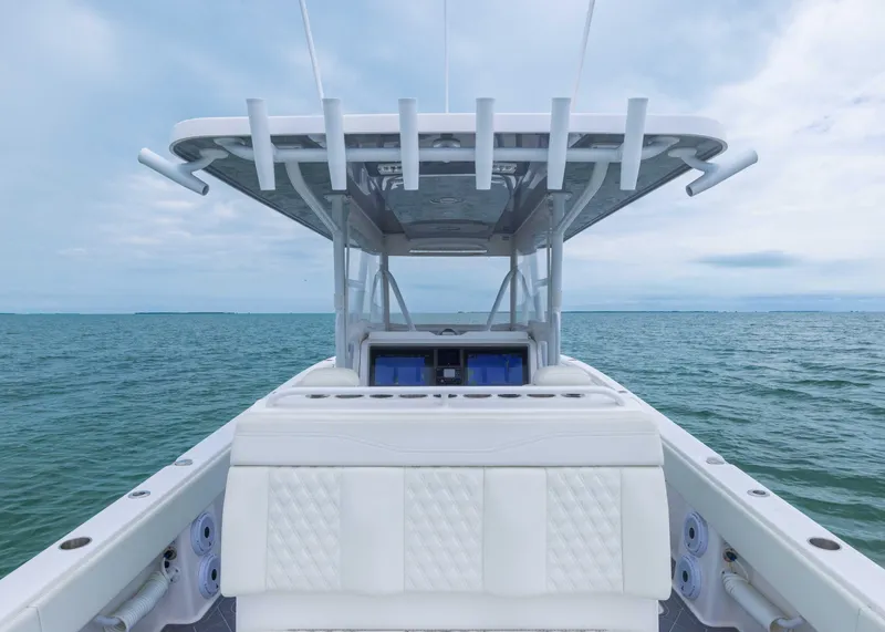 Slide: The Image of 2023 Invincible 33 Catamaran on open water, showcasing sleek design and spacious deck. - 34