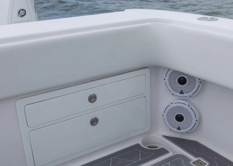 Slide: The Image of 2023 Invincible 33 Catamaran interior with storage drawers and marine speakers. - 37