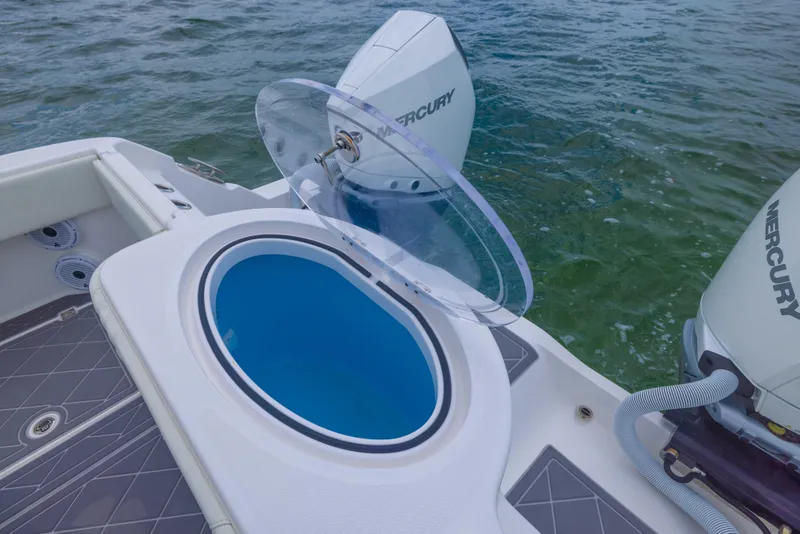 Slide: The Image of 2023 Invincible 33 Catamaran with open livewell and Mercury outboard engines on water. - 38