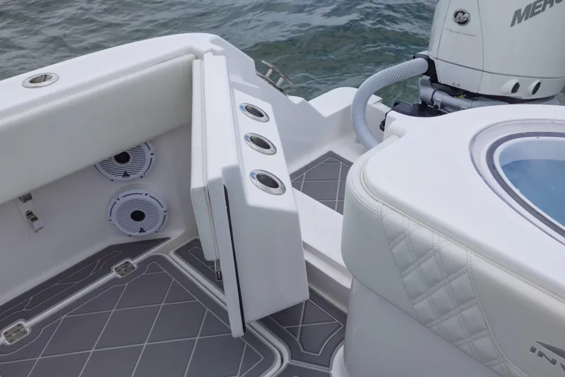 Slide: The Image of 2023 Invincible 33 Catamaran boat interior with seating, speakers, and motor detail. - 39