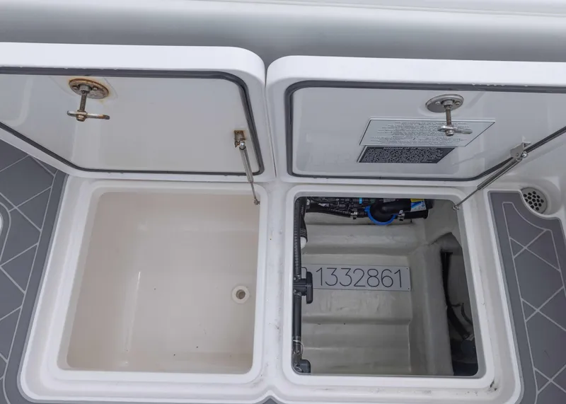 Slide: The Image of Open storage compartments on a 2023 Invincible 33 Catamaran boat deck. - 40