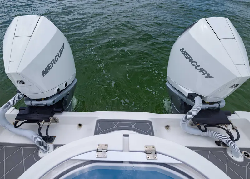 Slide: The Image of 2023 Invincible 33 Catamaran with dual Mercury outboard engines on water. - 43