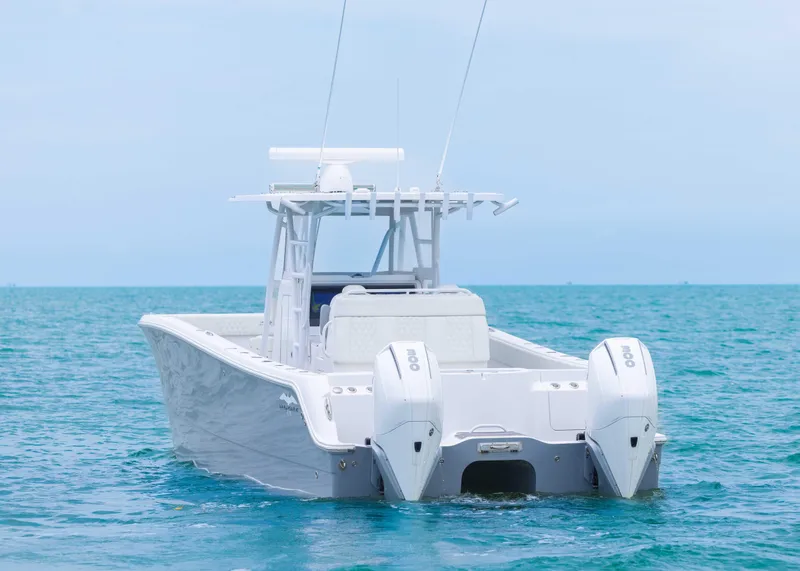 Slide: The Image of 2023 Invincible 33 Catamaran on open water, showcasing twin engines and sleek design. - 5