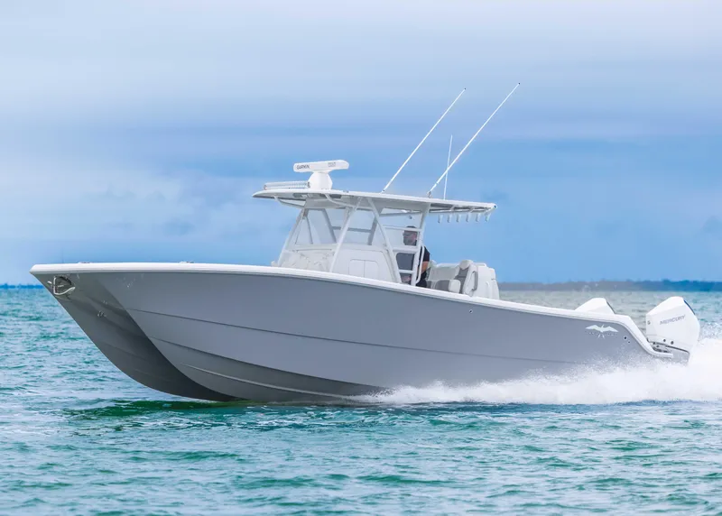 Slide: The Image of 2023 Invincible 33 Catamaran cruising on open water, showcasing sleek design and powerful performance. - 7