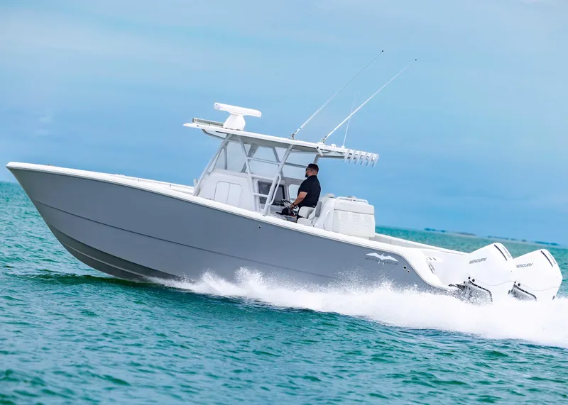 Slide: The Image of 2023 Invincible 33 Catamaran speeding on ocean, showcasing sleek design and powerful performance. - 8