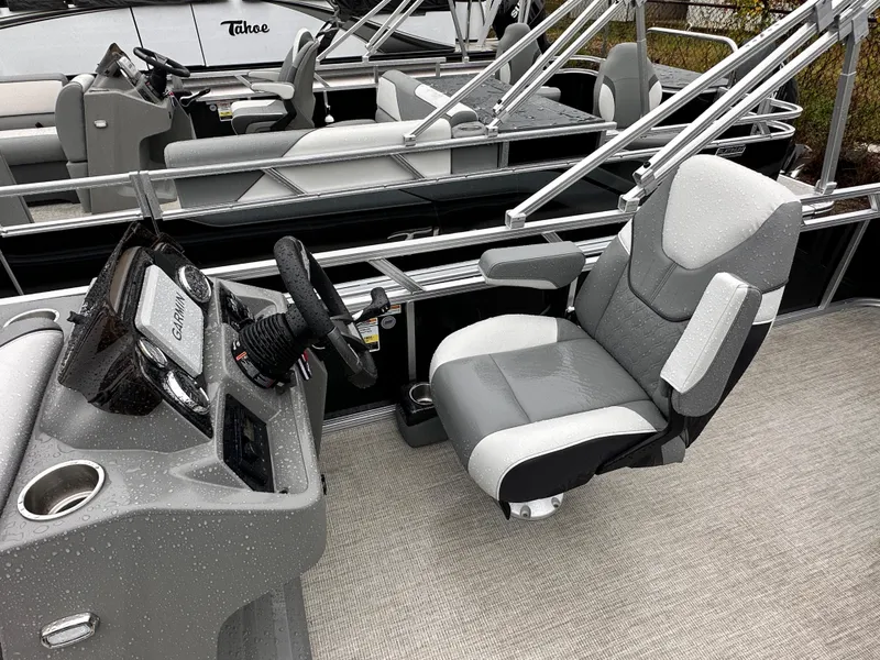 Slide: The Image of 2024 Tahoe Pontoon Sport Cruise interior with captain's chair and steering console. - 11