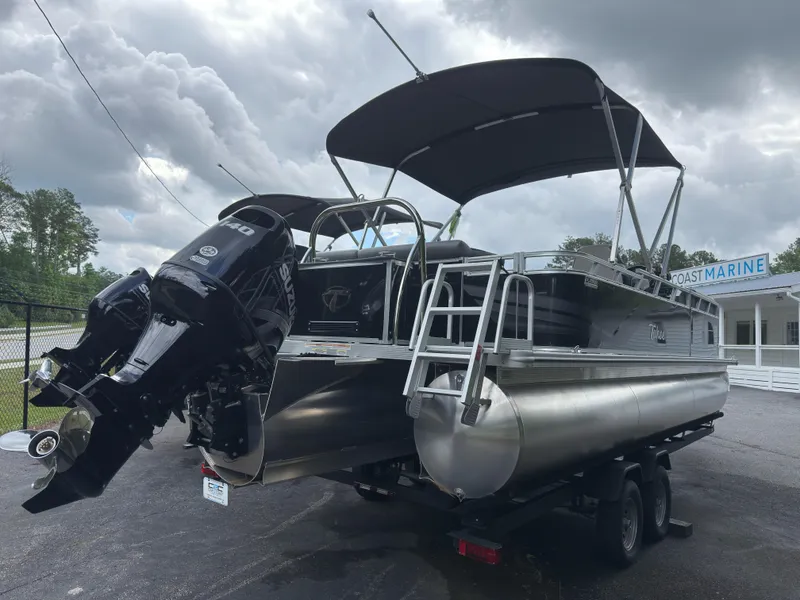 Slide: The Image of 2024 Tahoe Pontoon Sport Cruise boat with canopy and outboard motor on trailer. - 5