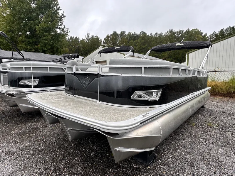 Slide: The Image of 2024 Tahoe Pontoon Sport Cruise boat parked on gravel near trees. - 6