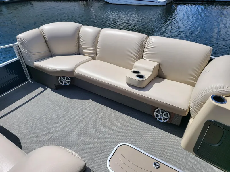 Slide: The Image of 2017 Godfrey Sweetwater 215c boat interior with beige seating and cup holders. - 12