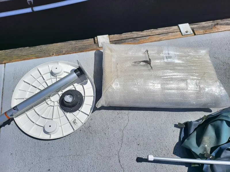 Slide: The Image of Boat equipment on deck of 2017 Godfrey Sweetwater 215c, including a wrapped package and metal pole. - 18