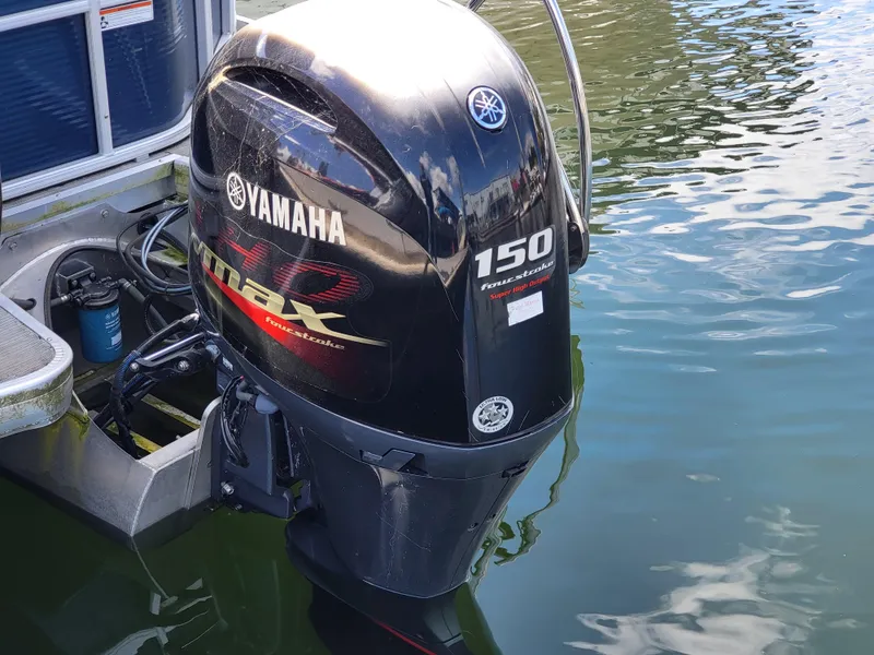 Slide: The Image of Yamaha 150 outboard motor on 2017 Godfrey Sweetwater 215c pontoon boat in water. - 6