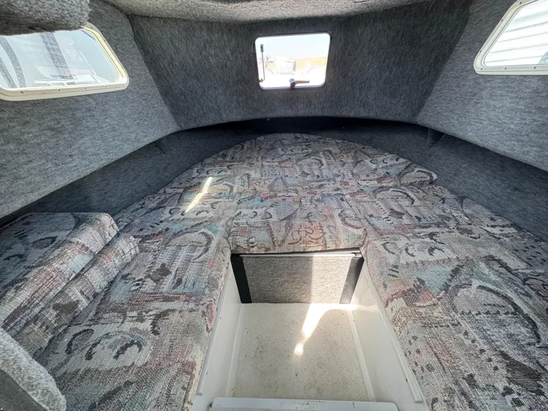 Slide: The Image of Interior cabin of 2001 Davis 22 Cortez boat with patterned upholstery and windows. - 11