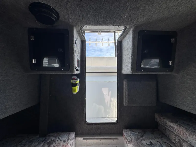 Slide: The Image of Interior of 2001 Davis 22 Cortez boat cabin with window and storage compartments. - 12
