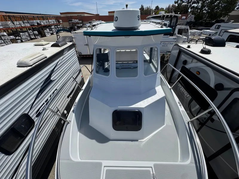 Slide: The Image of 2001 Davis 22 Cortez boat docked between RVs in a storage facility. - 13