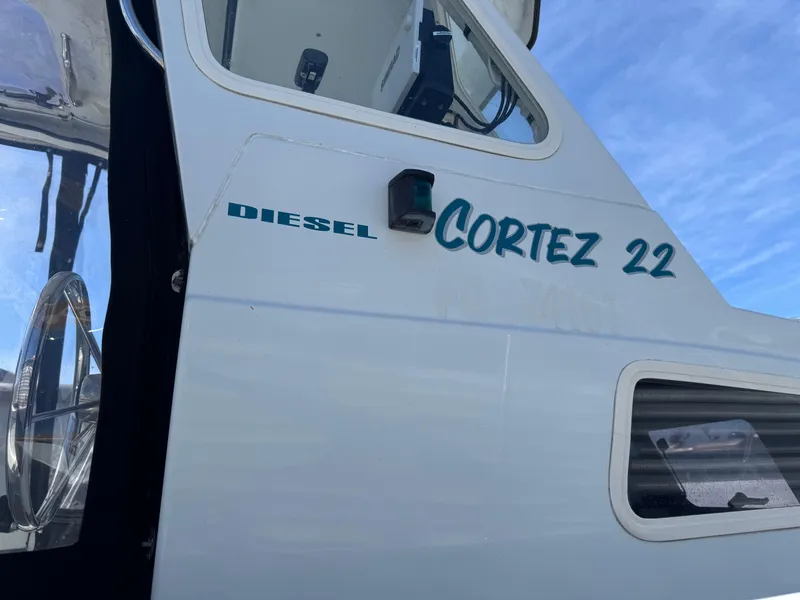 Slide: The Image of 2001 Davis Cortez 22 boat with diesel engine, side view against blue sky. - 4
