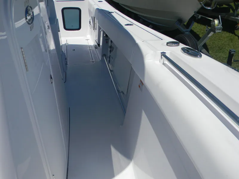 Slide: The Image of 2025 Sportsman Open 302 Center Console boat interior, featuring sleek white design and spacious layout. - 11
