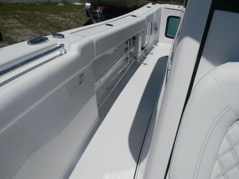 Slide: The Image of 2025 Sportsman Open 302 Center Console boat interior, featuring sleek white design and seating. - 12