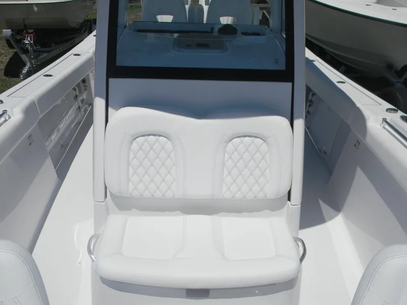 Slide: The Image of 2025 Sportsman Open 302 Center Console boat with white cushioned seating and sleek design. - 14