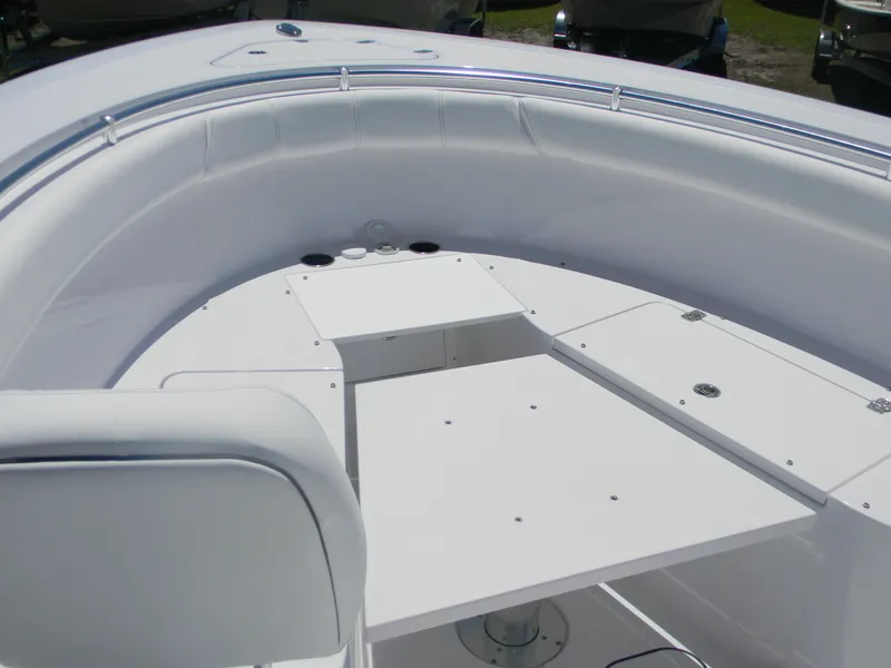 Slide: The Image of 2025 Sportsman Open 302 Center Console boat interior, featuring sleek white seating and deck design. - 15