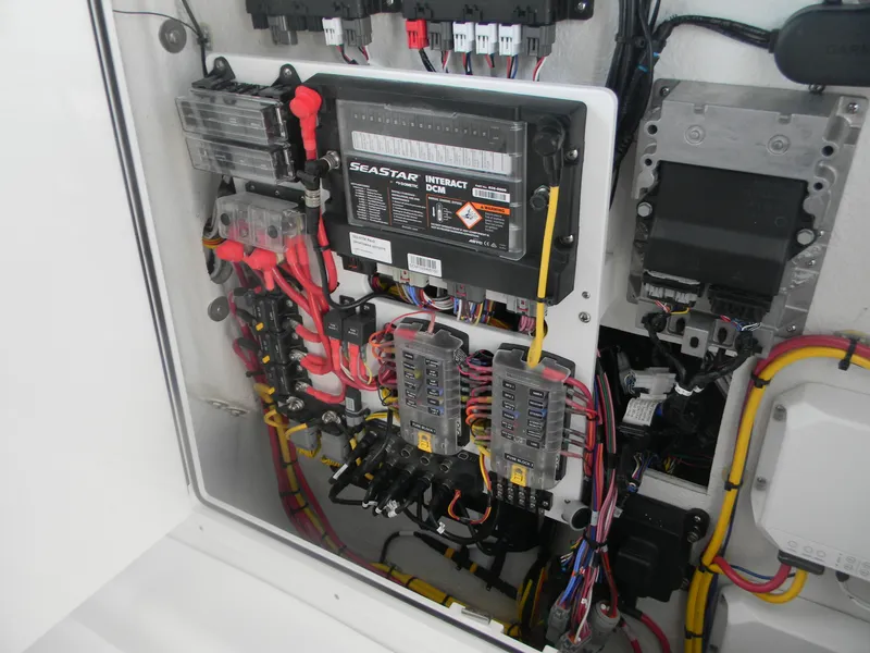 Slide: The Image of Electrical panel of 2025 Sportsman Open 302 Center Console with wiring and components. - 16