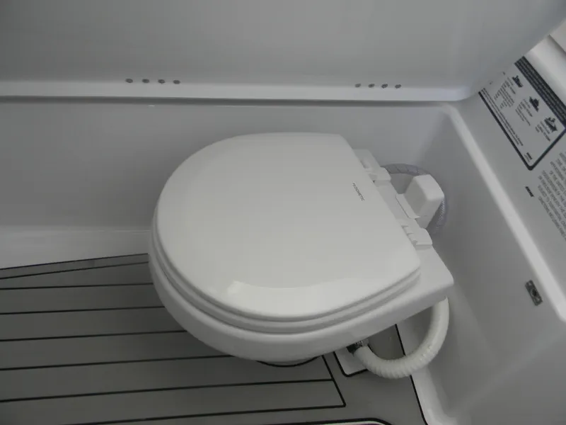 Slide: The Image of 2025 Sportsman Open 302 Center Console boat toilet, white and compact design. - 18