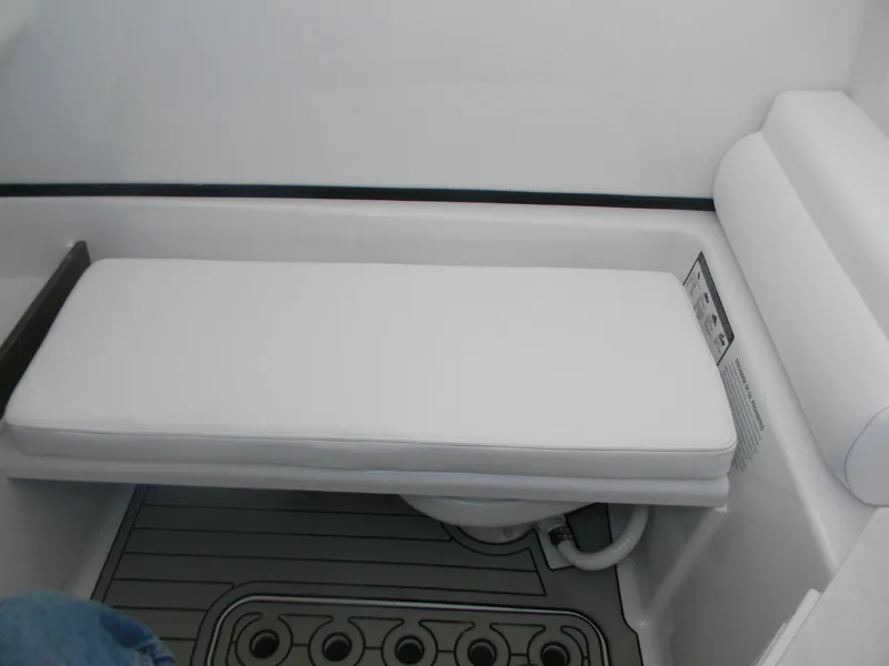 Slide: The Image of 2025 Sportsman Open 302 Center Console interior seating with white cushion and gray flooring. - 19