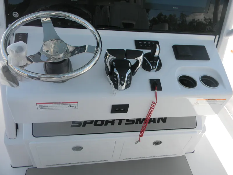 Slide: The Image of 2025 Sportsman Open 302 Center Console helm with steering wheel and controls. - 21