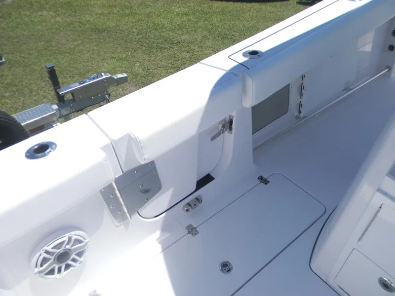 Slide: The Image of 2025 Sportsman Open 302 Center Console boat interior with white seating and speaker. - 7